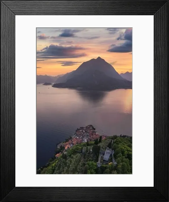 Framed Print : Vertical panoramic aerial view of Vezio Castle with Varenna village and mountains in background during summer sunset Framed Print : Vertical panoramic aerial view of Vezio Castle with Varenna village and mountains in background during summer sunset