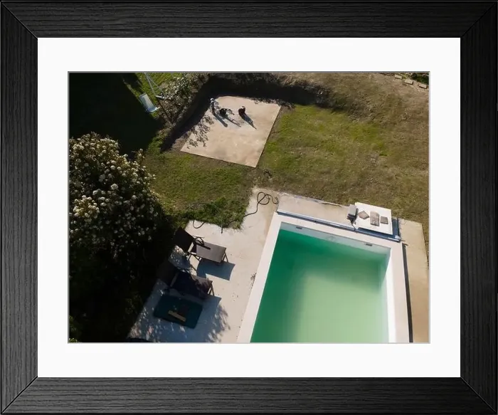 Framed Print : Drone flight over pool in the middle of greenery, fresh grass grown and the pool is not yet cleaned Framed Print : Drone flight over pool in the middle of greenery, fresh grass grown and the pool is not yet cleaned
