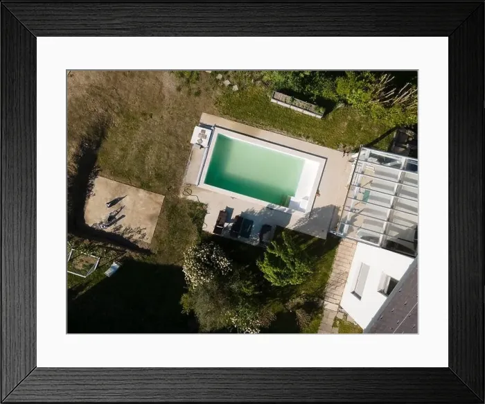 Framed Print : Drone flight over pool in the middle of greenery, fresh grass grown and the pool is not yet cleaned Framed Print : Drone flight over pool in the middle of greenery, fresh grass grown and the pool is not yet cleaned