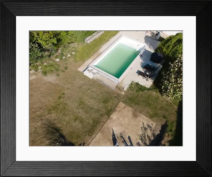Framed Print : Drone flight over pool in the middle of greenery, fresh grass grown and the pool is not yet cleaned Framed Print : Drone flight over pool in the middle of greenery, fresh grass grown and the pool is not yet cleaned