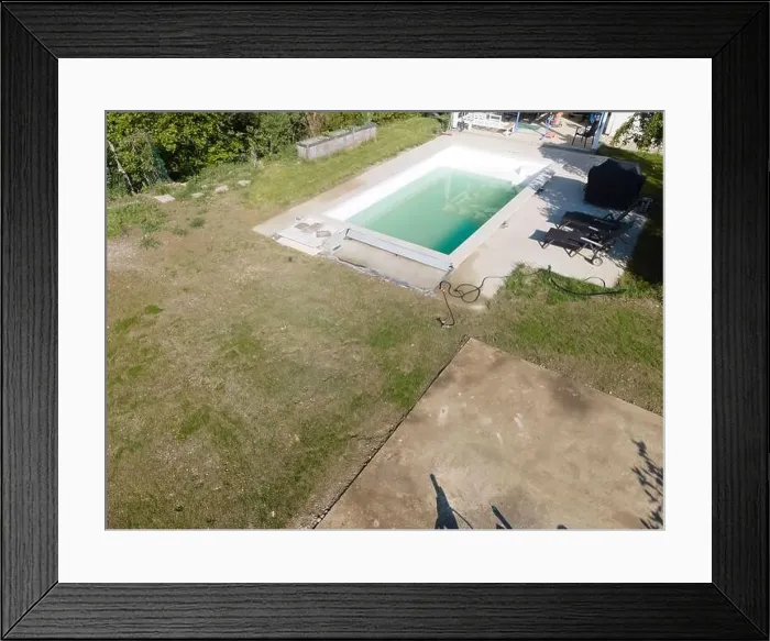 Framed Print : Drone flight over pool in the middle of greenery, fresh grass grown and the pool is not yet cleaned Framed Print : Drone flight over pool in the middle of greenery, fresh grass grown and the pool is not yet cleaned