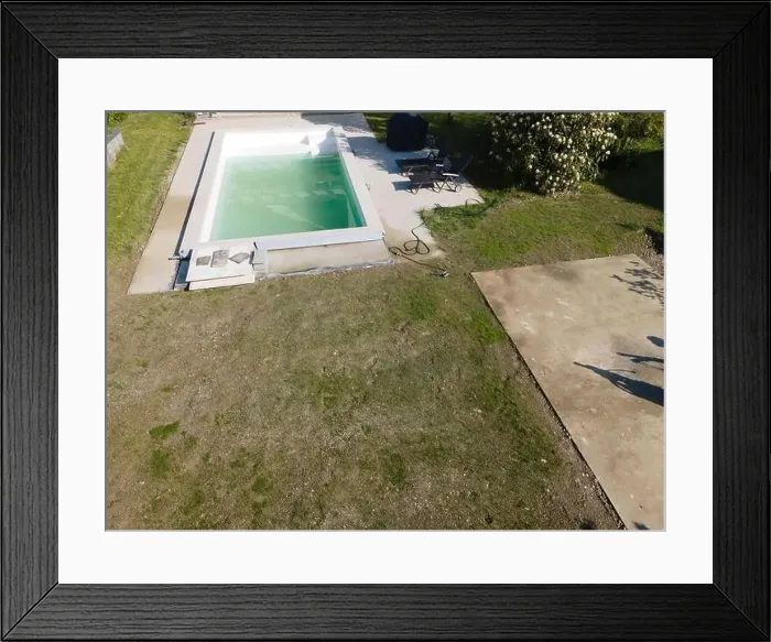 Framed Print : Drone flight over pool in the middle of greenery, fresh grass grown and the pool is not yet cleaned Framed Print : Drone flight over pool in the middle of greenery, fresh grass grown and the pool is not yet cleaned
