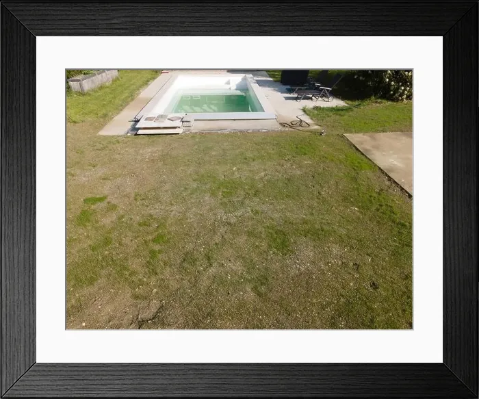 Framed Print : Drone flight over pool in the middle of greenery, fresh grass grown and the pool is not yet cleaned Framed Print : Drone flight over pool in the middle of greenery, fresh grass grown and the pool is not yet cleaned