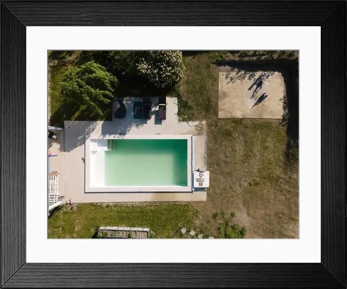 Framed Print : Drone flight over pool in the middle of greenery, fresh grass grown and the pool is not yet cleaned Framed Print : Drone flight over pool in the middle of greenery, fresh grass grown and the pool is not yet cleaned
