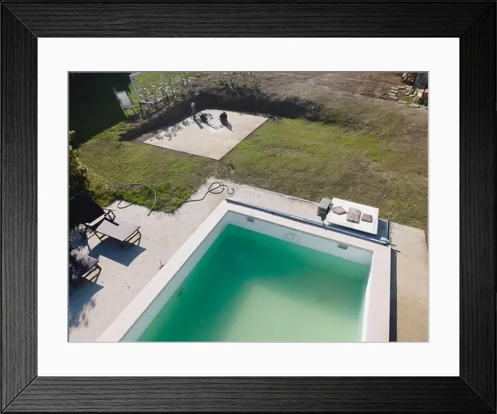 Framed Print : Drone flight over pool in the middle of greenery, fresh grass grown and the pool is not yet cleaned Framed Print : Drone flight over pool in the middle of greenery, fresh grass grown and the pool is not yet cleaned