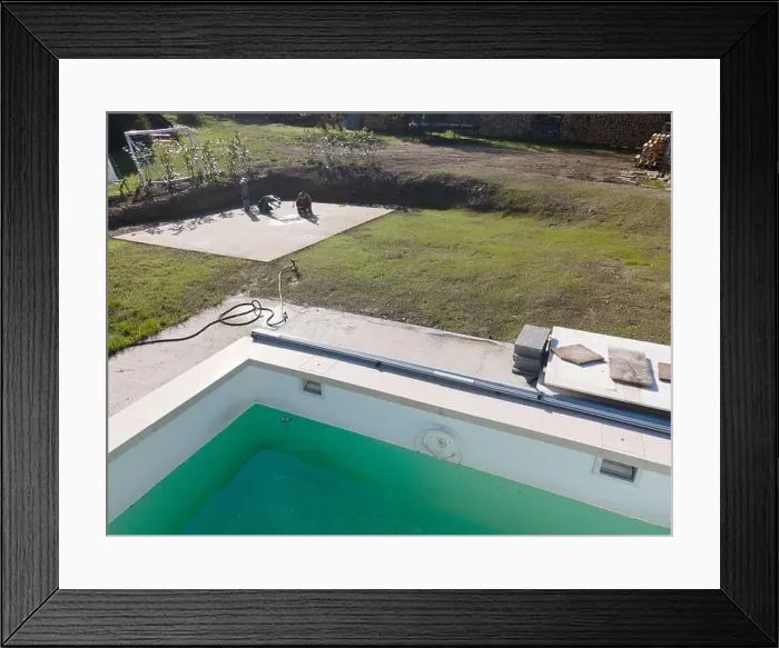 Framed Print : Drone flight over pool in the middle of greenery, fresh grass grown and the pool is not yet cleaned Framed Print : Drone flight over pool in the middle of greenery, fresh grass grown and the pool is not yet cleaned