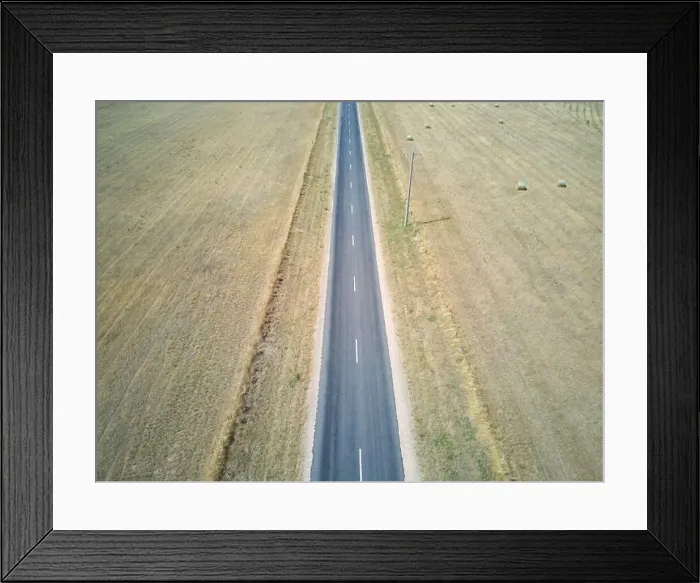 Framed Print : Australia highway aerial view showing rural highway, farmland and round hay bales, Victoria, Australia Framed Print : Australia highway aerial view showing rural highway, farmland and round hay bales, Victoria, Australia