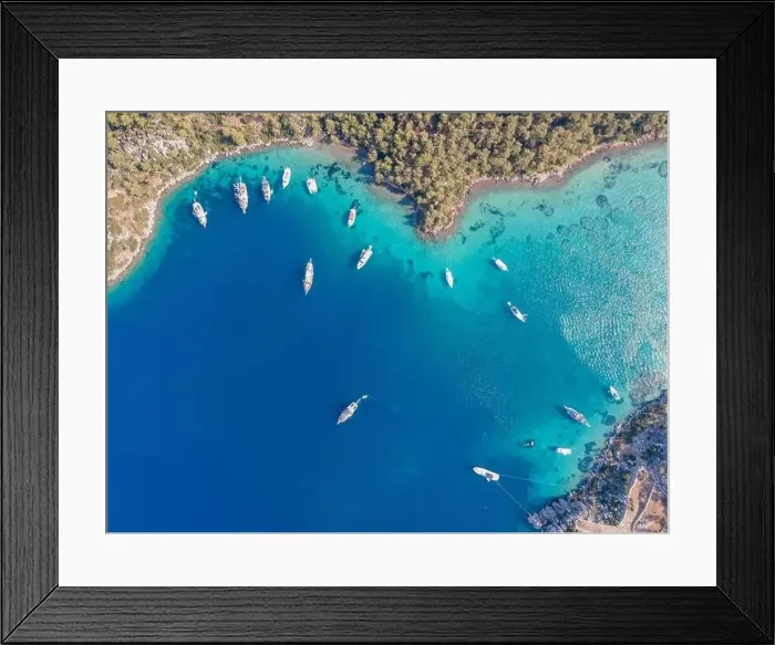 Framed Print : Aerial drone footage of daily tour boats and private yachts anchored in Cennet Bay Framed Print : Aerial drone footage of daily tour boats and private yachts anchored in Cennet Bay