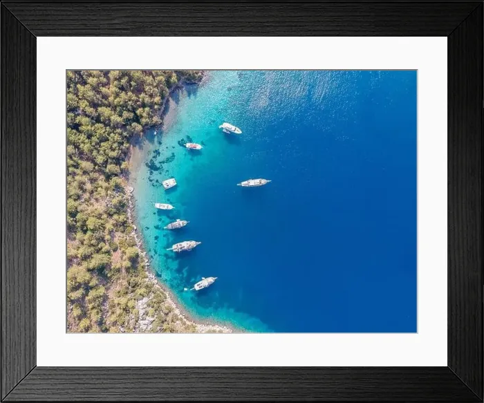 Framed Print : Aerial drone footage of daily tour boats and private yachts anchored in Cennet Bay Framed Print : Aerial drone footage of daily tour boats and private yachts anchored in Cennet Bay