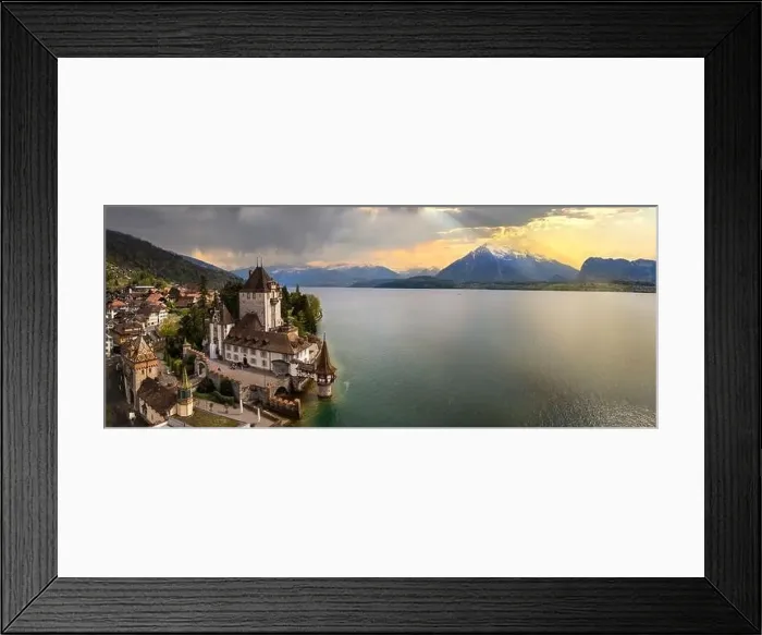 Framed Print : Aerial view of amazing romantic castle Oberhofen over sunset light. scenic Thun lake, Switzerland travel and landmarks Framed Print : Aerial view of amazing romantic castle Oberhofen over sunset light. scenic Thun lake, Switzerland travel and landmarks