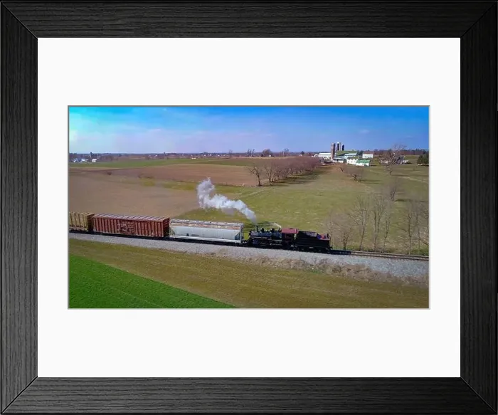 Framed Print : Aerial View of an Antique Steam Engine Doing Switching Dues at a Freight Yard in the Middle of Farmlands on a Sunny Day Framed Print : Aerial View of an Antique Steam Engine Doing Switching Dues at a Freight Yard in the Middle of Farmlands on a Sunny Day