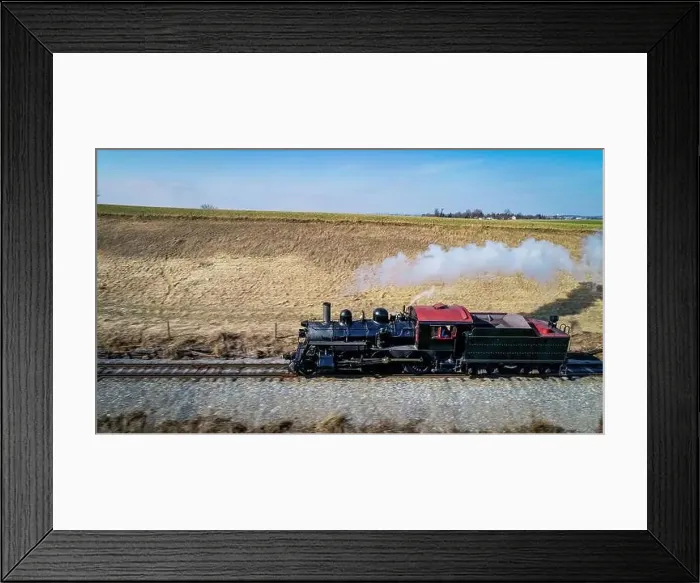 Framed Print : Aerial View of an Antique Steam Engine Traveling by Itself in the Middle of Farmlands on Sunny Day Framed Print : Aerial View of an Antique Steam Engine Traveling by Itself in the Middle of Farmlands on Sunny Day