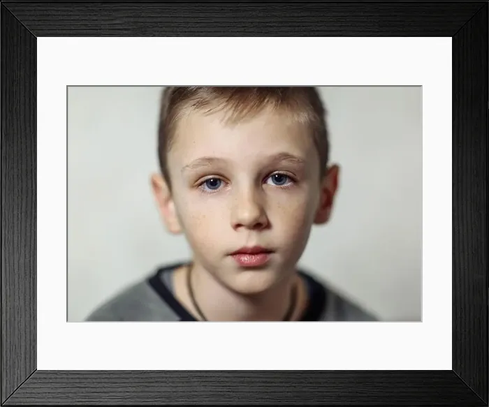 Framed Print : close-up portrait of serious caucasian boy with freckles in casual wear, boy looking in camera Framed Print : close-up portrait of serious caucasian boy with freckles in casual wear, boy looking in camera