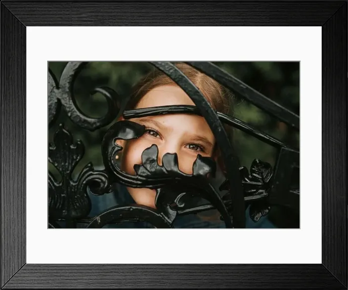Framed Print : portrait happy candid eight year old caucasian kid girl brown eyes peeking through of abstract metal shapes in nature Framed Print : portrait happy candid eight year old caucasian kid girl brown eyes peeking through of abstract metal shapes in nature