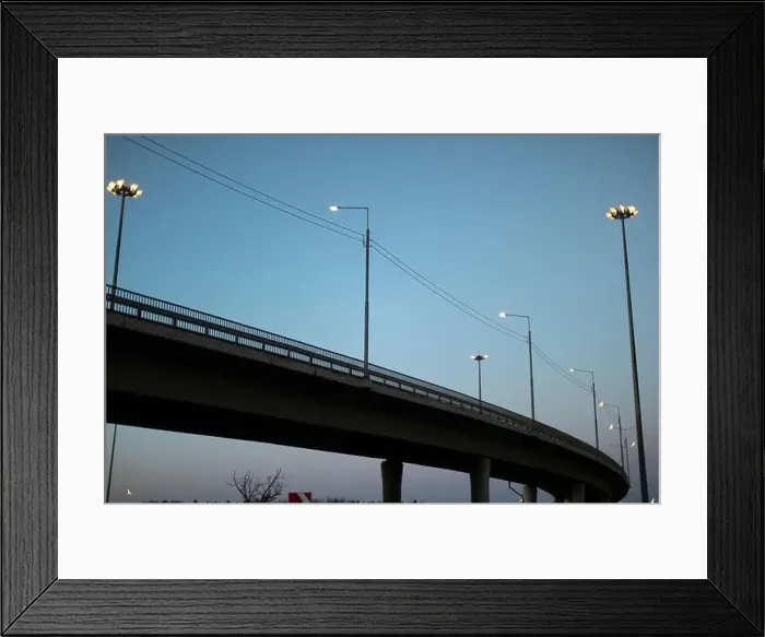 Framed Print : Evening view of track. Cityscape. Chaus at sunset. Poles with lamps along road Framed Print : Evening view of track. Cityscape. Chaus at sunset. Poles with lamps along road