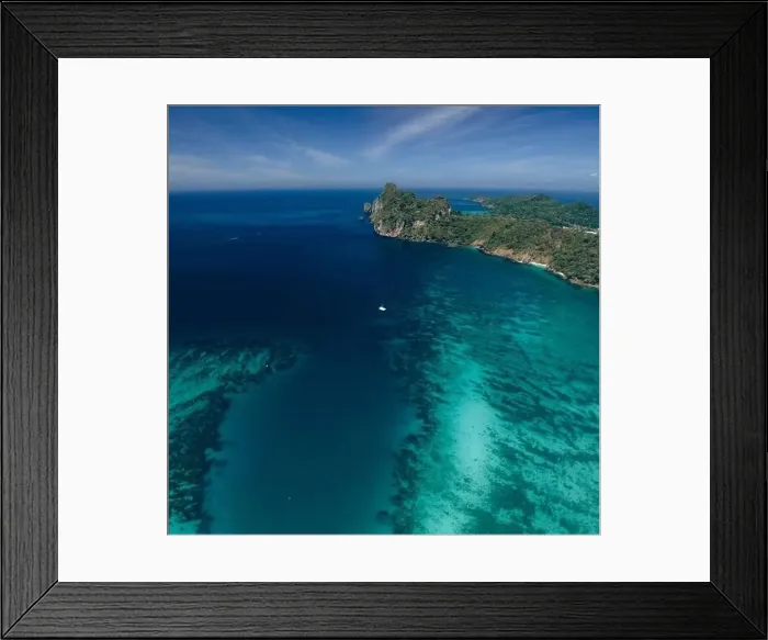 Framed Print : Single boat in a paradisiacal reef bay in Thailand