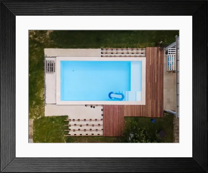 Framed Print : Drone flight over beautiful green garden with pool and the wooden terrace of the pool is currently in progress Framed Print : Drone flight over beautiful green garden with pool and the wooden terrace of the pool is currently in progress