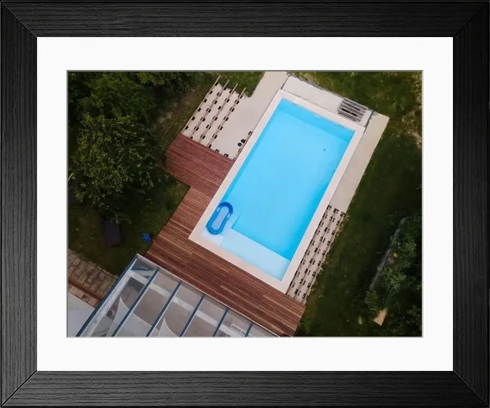 Framed Print : Drone flight over beautiful green garden with pool and the wooden terrace of the pool is currently in progress Framed Print : Drone flight over beautiful green garden with pool and the wooden terrace of the pool is currently in progress