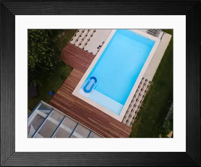Framed Print : Drone flight over beautiful green garden with pool and the wooden terrace of the pool is currently in progress Framed Print : Drone flight over beautiful green garden with pool and the wooden terrace of the pool is currently in progress