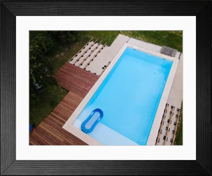 Framed Print : Drone flight over beautiful green garden with pool and the wooden terrace of the pool is currently in progress Framed Print : Drone flight over beautiful green garden with pool and the wooden terrace of the pool is currently in progress