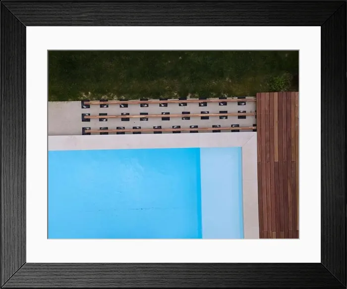 Framed Print : Drone flight over beautiful green garden with pool and the wooden terrace of the pool is currently in progress Framed Print : Drone flight over beautiful green garden with pool and the wooden terrace of the pool is currently in progress