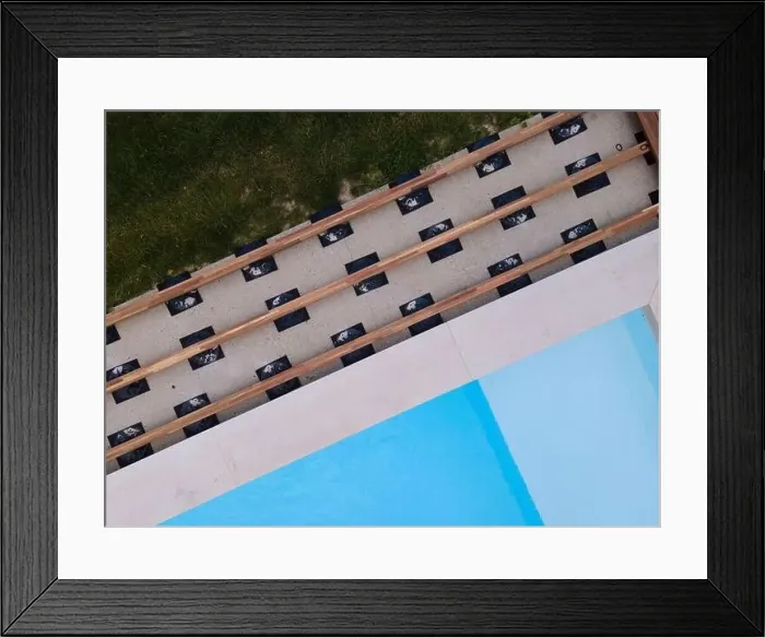 Framed Print : Drone flight over beautiful green garden with pool and the wooden terrace of the pool is currently in progress Framed Print : Drone flight over beautiful green garden with pool and the wooden terrace of the pool is currently in progress