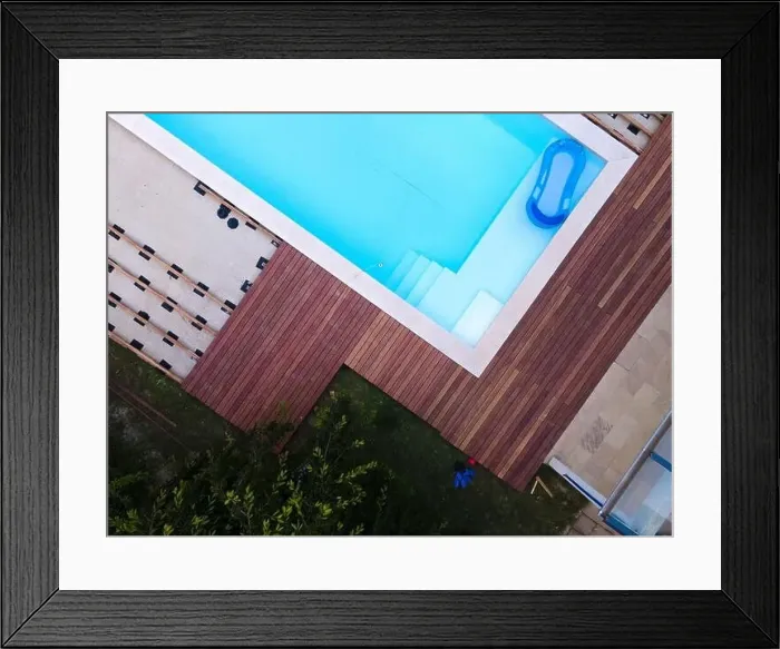 Framed Print : Drone flight over beautiful green garden with pool and the wooden terrace of the pool is currently in progress Framed Print : Drone flight over beautiful green garden with pool and the wooden terrace of the pool is currently in progress