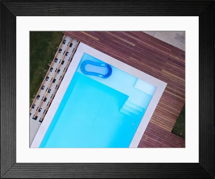 Framed Print : Drone flight over beautiful green garden with pool and the wooden terrace of the pool is currently in progress Framed Print : Drone flight over beautiful green garden with pool and the wooden terrace of the pool is currently in progress