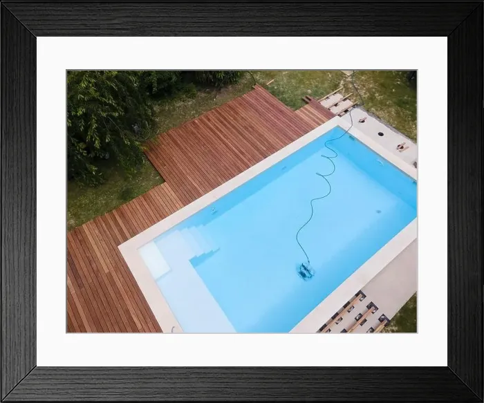 Framed Print : aerial drone flight over beautiful green garden with pool and the wooden deck of the pool is in progress Framed Print : aerial drone flight over beautiful green garden with pool and the wooden deck of the pool is in progress