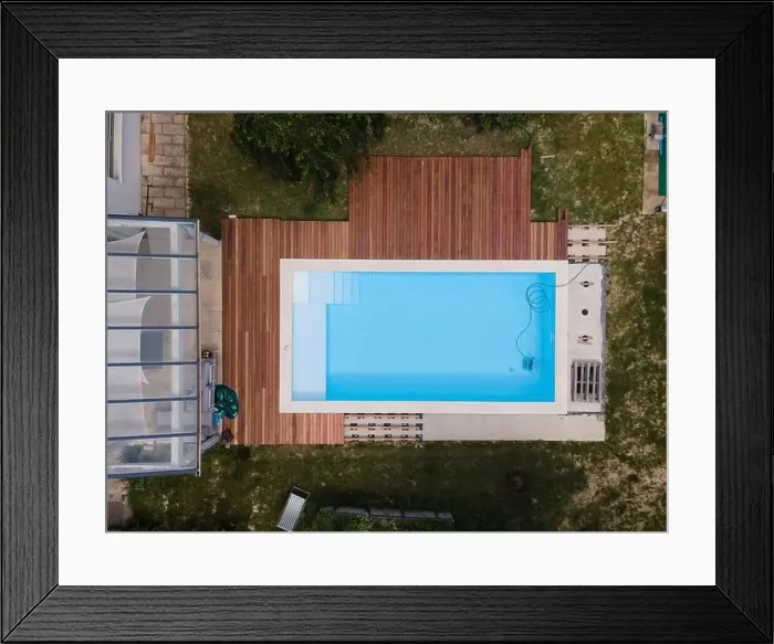 Framed Print : aerial drone flight over beautiful green garden with pool and the wooden deck of the pool is in progress Framed Print : aerial drone flight over beautiful green garden with pool and the wooden deck of the pool is in progress