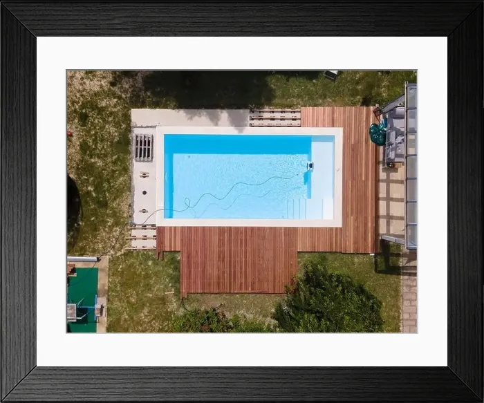Framed Print : aerial drone flight over beautiful green garden with pool and the wooden deck of the pool is in progress Framed Print : aerial drone flight over beautiful green garden with pool and the wooden deck of the pool is in progress