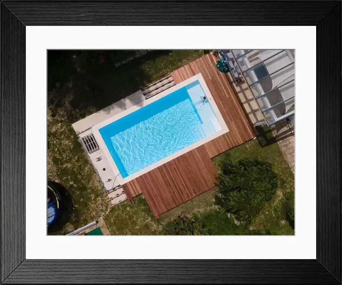 Framed Print : aerial drone flight over beautiful green garden with pool and the wooden deck of the pool is in progress Framed Print : aerial drone flight over beautiful green garden with pool and the wooden deck of the pool is in progress