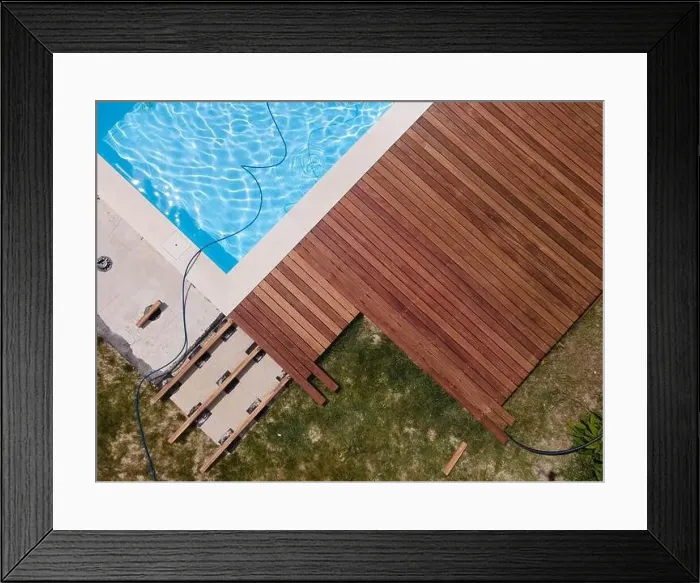 Framed Print : aerial drone flight over beautiful green garden with pool and the wooden deck of the pool is in progress Framed Print : aerial drone flight over beautiful green garden with pool and the wooden deck of the pool is in progress