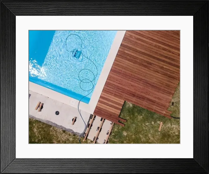 Framed Print : aerial drone flight over beautiful green garden with pool and the wooden deck of the pool is in progress Framed Print : aerial drone flight over beautiful green garden with pool and the wooden deck of the pool is in progress