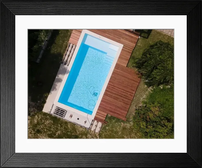 Framed Print : aerial drone flight over beautiful green garden with pool and the wooden deck of the pool is in progress Framed Print : aerial drone flight over beautiful green garden with pool and the wooden deck of the pool is in progress