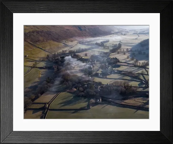 Framed Print : Drone shot shows morning Mist and smoke from a chimney float above yorkshire dales village of arncliffe Framed Print : Drone shot shows morning Mist and smoke from a chimney float above yorkshire dales village of arncliffe