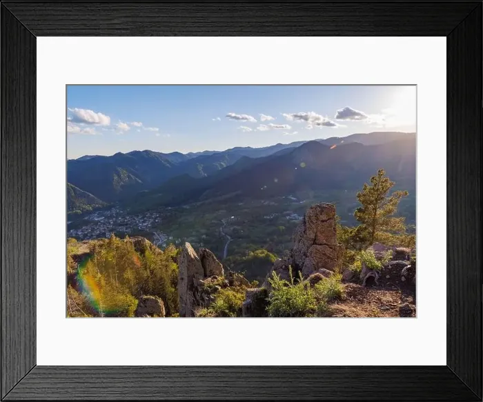 Framed Print : View from high rock to old village town of Smolyan with green meadows for cattle walking and ancient houses Framed Print : View from high rock to old village town of Smolyan with green meadows for cattle walking and ancient houses