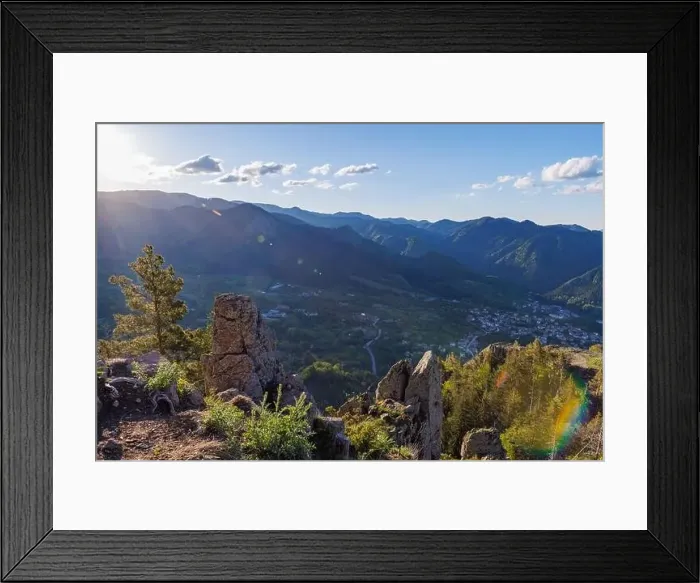 Framed Print : View from high rock to old village town of Smolyan with green meadows for cattle walking and ancient houses Framed Print : View from high rock to old village town of Smolyan with green meadows for cattle walking and ancient houses