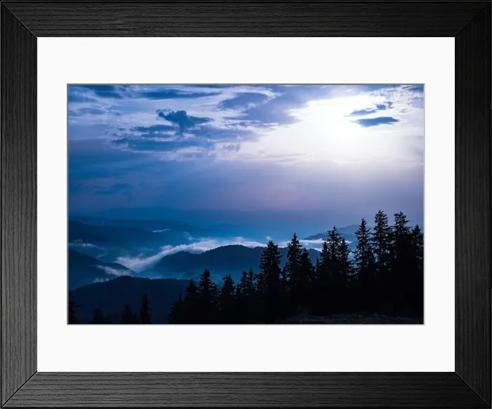Framed Print : Cold cloudy rainy weather over low hills covered with spruce evergreen forests in Rhodope Mountains against backdrop of
