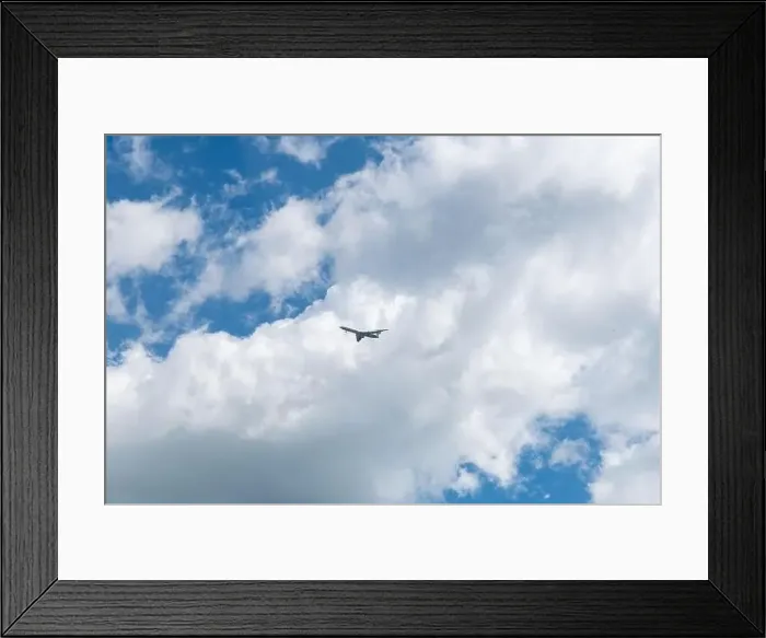 Framed Print : in a blue sky with beautiful clouds flies an airplane Framed Print : in a blue sky with beautiful clouds flies an airplane
