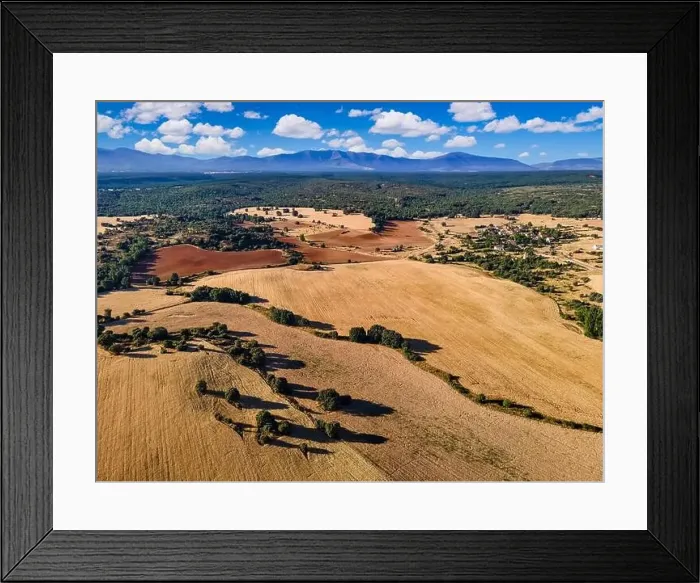 Framed Print : Aerial view of arable fields with blue sky and mountains in the background. Segovia Framed Print : Aerial view of arable fields with blue sky and mountains in the background. Segovia