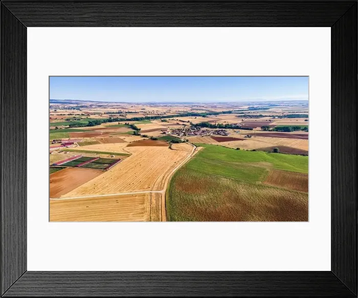 Framed Print : Aerial view of agricultural fields and rural town in the background. Segovia Framed Print : Aerial view of agricultural fields and rural town in the background. Segovia
