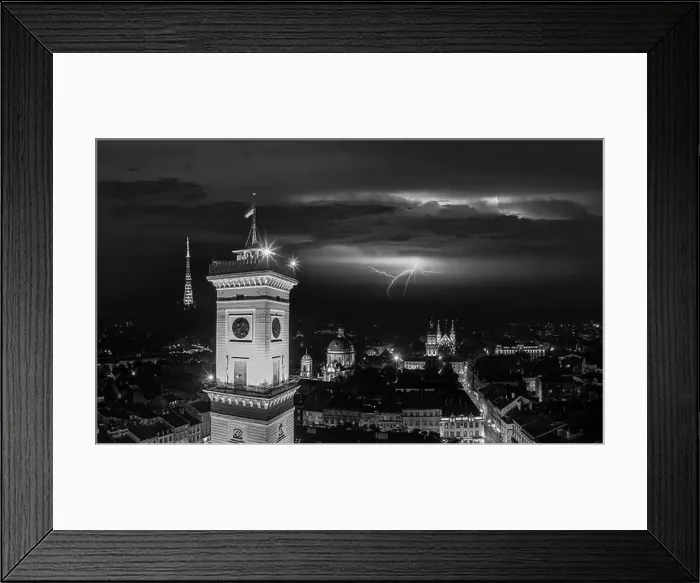 Framed Print : Aerial view on Lviv city hall at night from drone with lightning on the sky Framed Print : Aerial view on Lviv city hall at night from drone with lightning on the sky