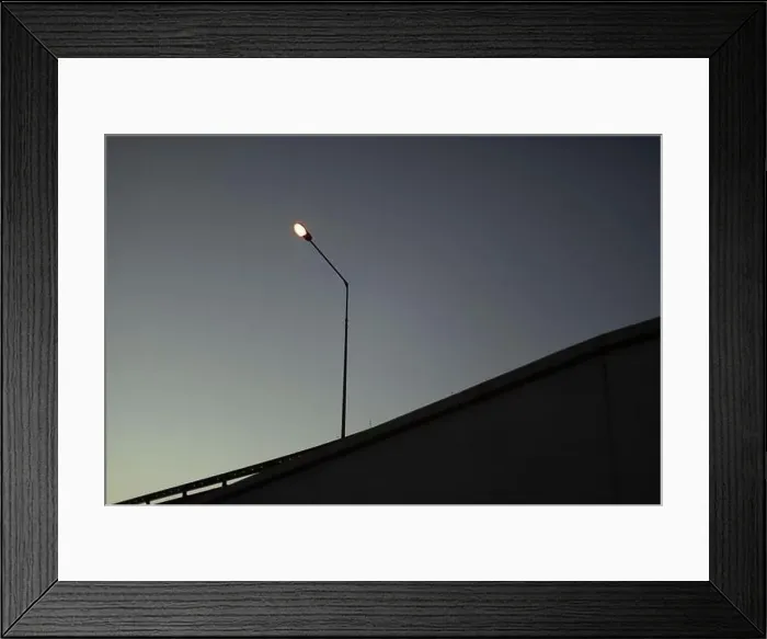 Framed Print : Evening view of track. Cityscape. Chaus at sunset. Poles with lamps along road Framed Print : Evening view of track. Cityscape. Chaus at sunset. Poles with lamps along road
