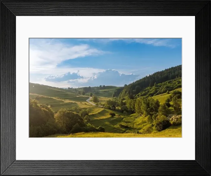 Framed Print : A narrow automobile paved intermountain road passes and meanders among low hills covered with spruce forests Framed Print : A narrow automobile paved intermountain road passes and meanders among low hills covered with spruce forests