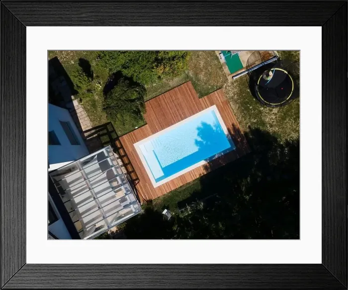 Framed Print : Drone flight over pool with nice wooden terrace surrounded by green lawn in beautiful garden Framed Print : Drone flight over pool with nice wooden terrace surrounded by green lawn in beautiful garden