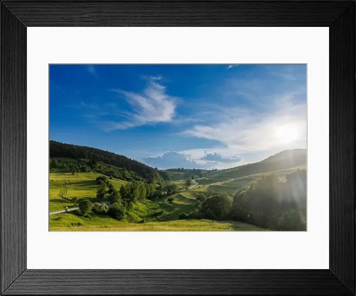 Framed Print : A narrow automobile paved intermountain road passes and meanders among low hills covered with spruce forests Framed Print : A narrow automobile paved intermountain road passes and meanders among low hills covered with spruce forests