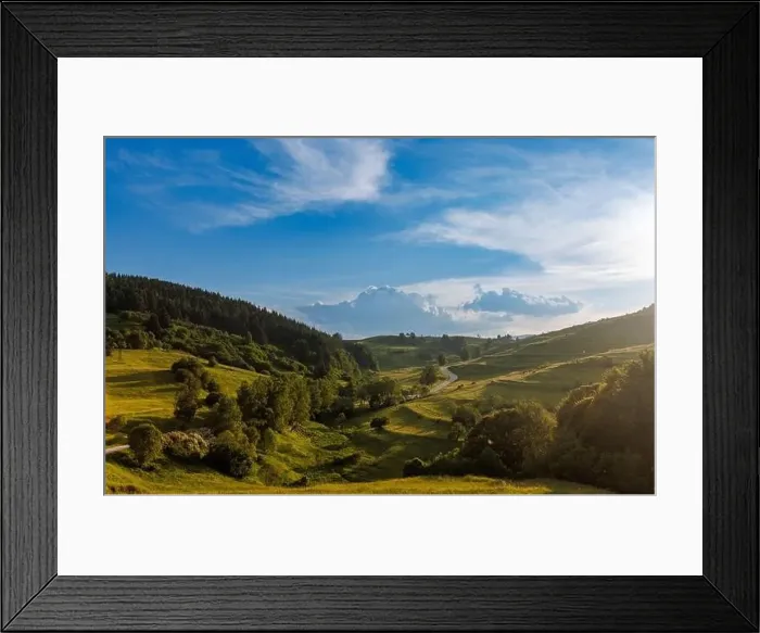 Framed Print : A narrow automobile paved intermountain road passes and meanders among low hills covered with spruce forests Framed Print : A narrow automobile paved intermountain road passes and meanders among low hills covered with spruce forests
