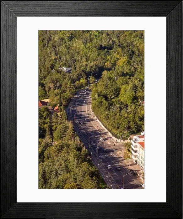 Framed Print : Top view of winding highway going through the forest at sunset Framed Print : Top view of winding highway going through the forest at sunset