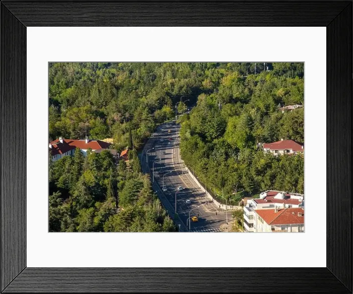 Framed Print : Top view of winding highway going through the forest at sunset Framed Print : Top view of winding highway going through the forest at sunset